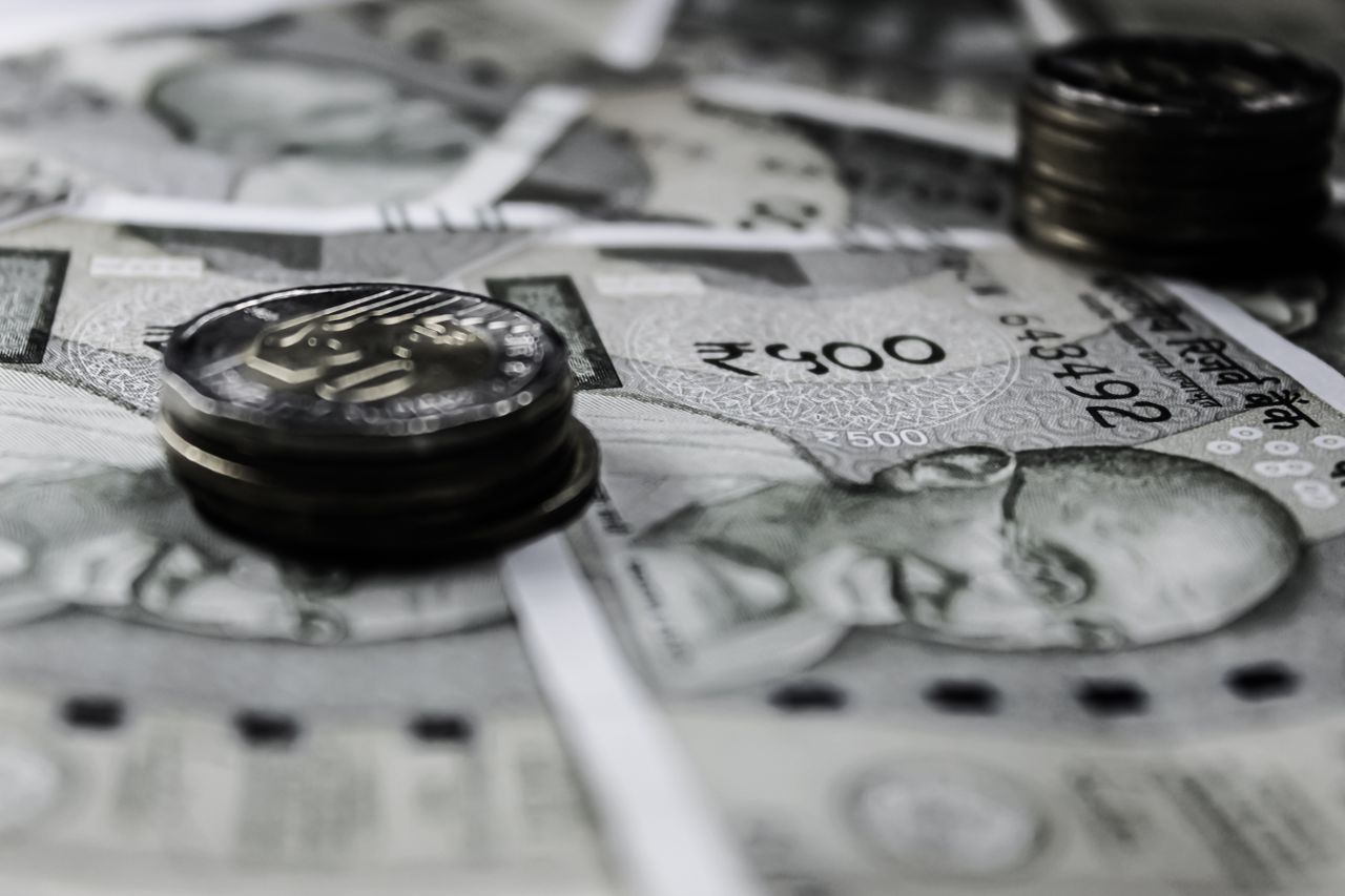 Hello world! A detailed close-up of Indian currency notes and coins, highlighting financial themes.