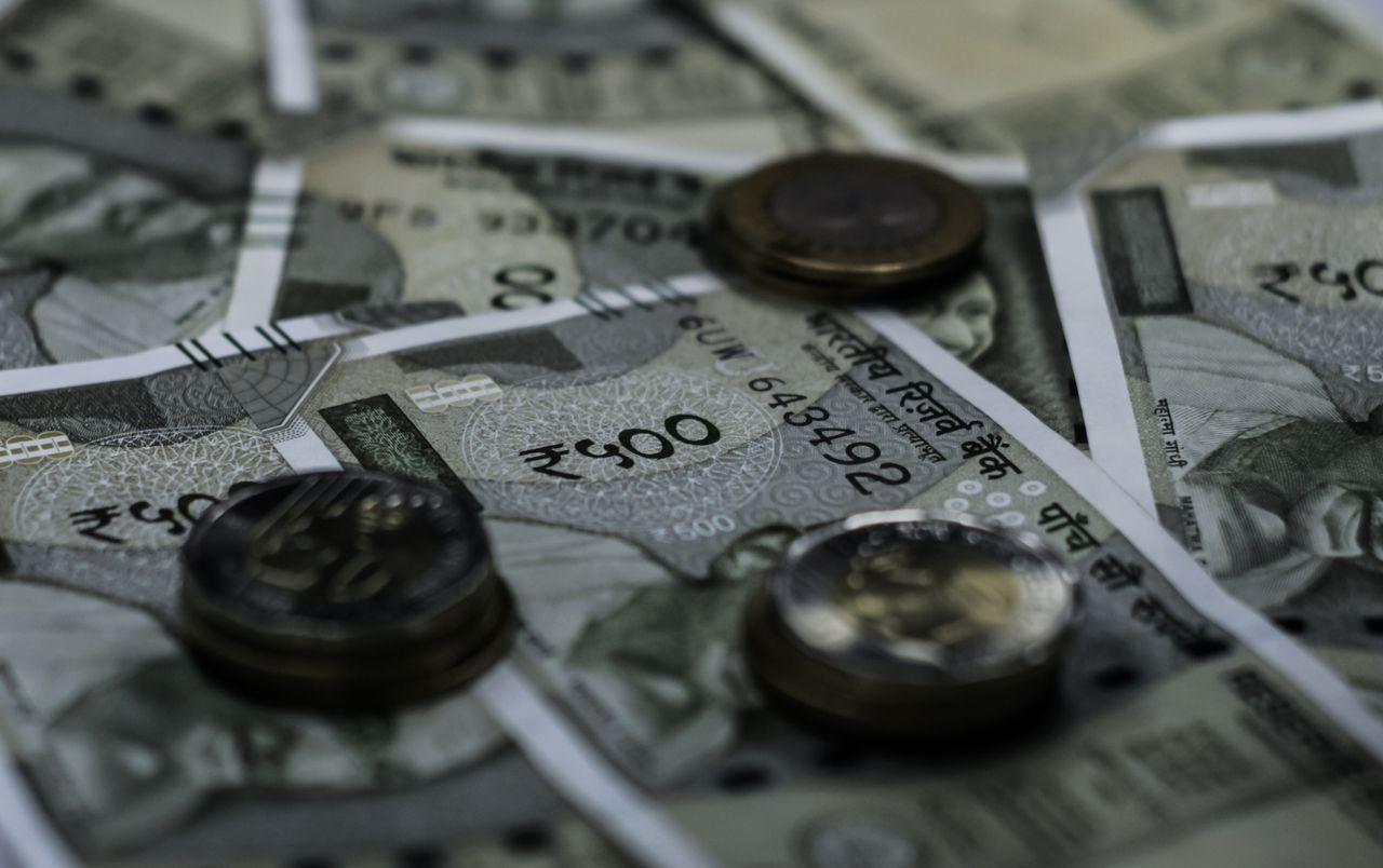 The Art of Drawing Readers In: Your attractive post title goes here Detailed view of Indian currency notes and coins representing wealth and finance.