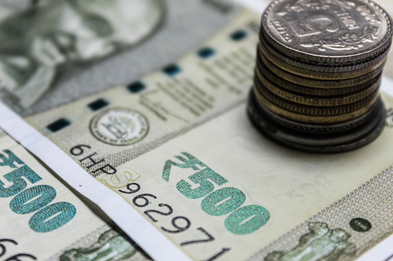 Mastering the First Impression: Your intriguing post title goes here Detailed view of Indian rupees and stacked coins, representing currency and finance.